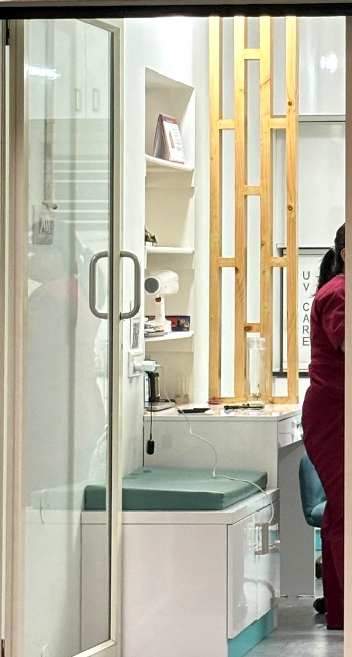 Inside Caring Smiles: shelves, a wooden partition and the patient seating area